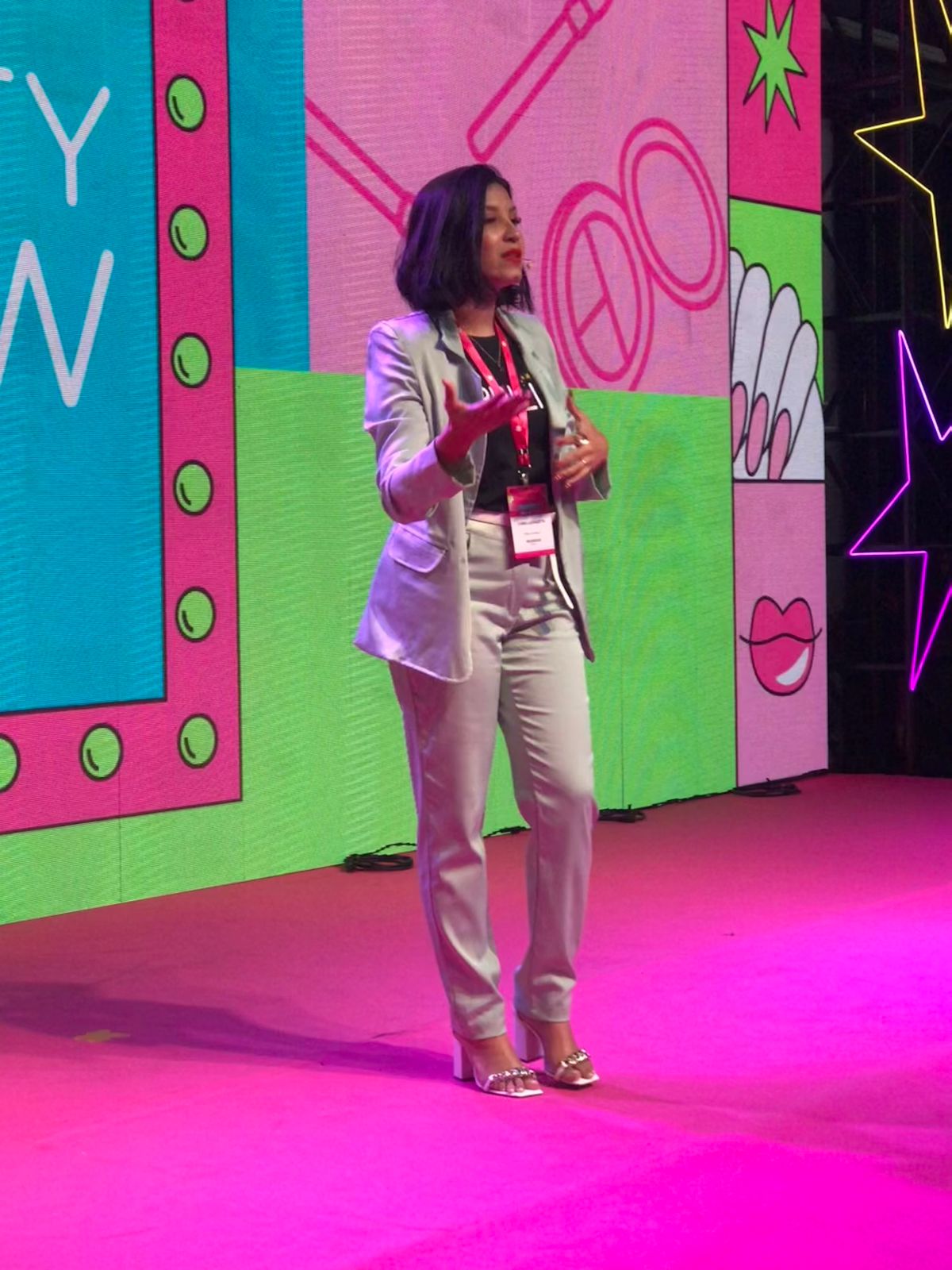 Camilla Gazeta presenting on stage at an event